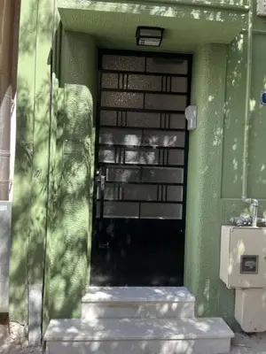 a door to a house with a green wall at Athens Classic Luxury 2-Bedroom Apartment in Athens