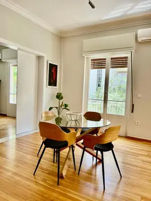 a dining room with a glass table and chairs at Athens Classic Luxury 2-Bedroom Apartment in Athens