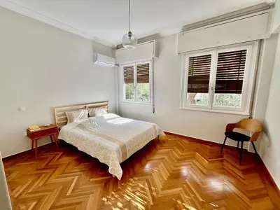 a bedroom with a bed and two windows at Athens Classic Luxury 2-Bedroom Apartment in Athens