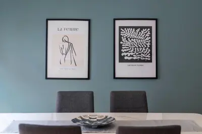 a dining room with three framed pictures on the wall at Spacious & bright 2br apt in hip Pangrati, Athens in Athens