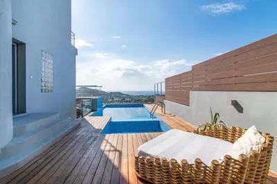 a balcony of a house with a swimming pool at Villa Azzura with sea view & private pool at Athens Riviera in Aghia Marina