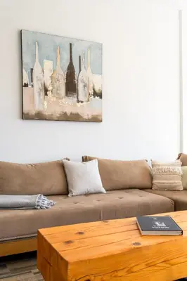 a living room with a couch and a table at Villa Azzura with sea view & private pool at Athens Riviera in Aghia Marina
