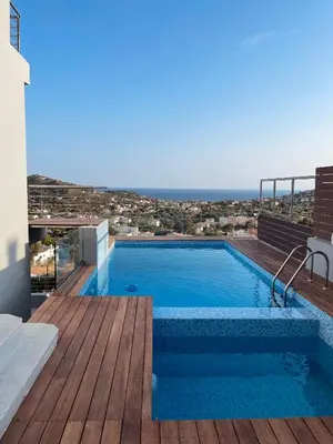 a swimming pool on top of a house at Villa Azzura with sea view & private pool at Athens Riviera in Aghia Marina