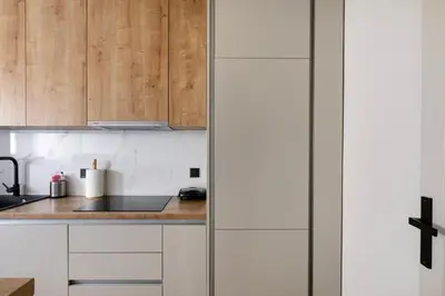 a kitchen with wooden cabinets and a counter top at Zeus 2-Bedroom Apartment in Athens in Athens