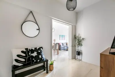 a living room with a mirror and a chair at Zeus 2-Bedroom Apartment in Athens in Athens