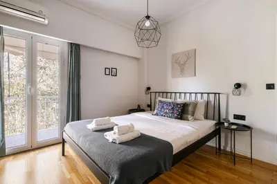 a bedroom with a bed with two towels on it at Zeus 2-Bedroom Apartment in Athens in Athens