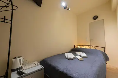 a bedroom with a bed with two towels on it at PURE URBAN BEDBOXES ACROPOLIS METRO PETRALONA in Athens