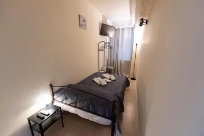 a bedroom with a bed with a teddy bear on it at PURE URBAN BEDBOXES ACROPOLIS METRO PETRALONA in Athens
