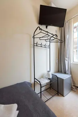 a bedroom with a bed and a tv on the wall at PURE URBAN BEDBOXES ACROPOLIS METRO PETRALONA in Athens