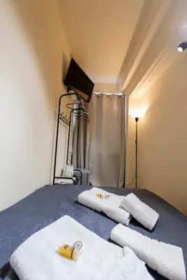 a bedroom with a bed with towels on it at PURE URBAN BEDBOXES ACROPOLIS METRO PETRALONA in Athens