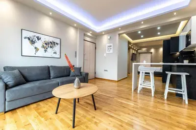 a living room with a couch and a table at Acropolis lux view penthouse in Athens