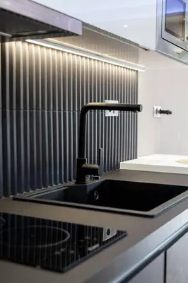 a black sink in a kitchen with a counter at Acropolis lux view penthouse in Athens