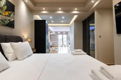 a bedroom with a large white bed with white pillows at Acropolis lux view penthouse in Athens