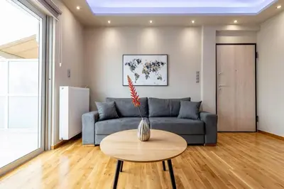 a living room with a couch and a table at Acropolis lux view penthouse in Athens