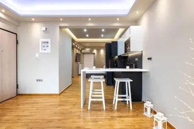 a kitchen with a counter and stools in a room at Acropolis lux view penthouse in Athens