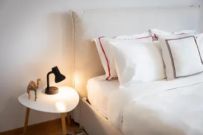 a bedroom with two beds and a lamp on a side table at Luxury Apartment, Athens Center, 