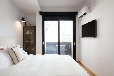 a bedroom with a white bed and a television at Luxury Apartment, Athens Center, 