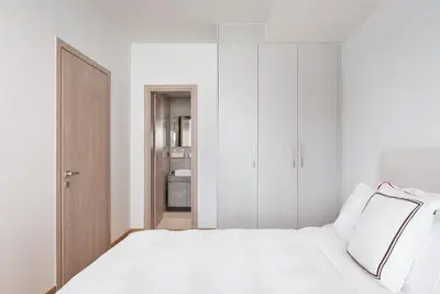 a bedroom with a white bed with white cabinets at Luxury Apartment, Athens Center, 
