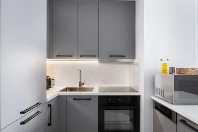 a kitchen with white cabinets and a sink and a microwave at Luxury Apartment, Athens Center, 