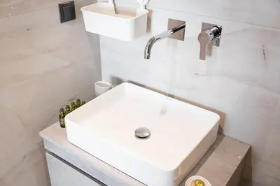 a white sink in a bathroom with white tiles at Luxury Apartment, Athens Center, 