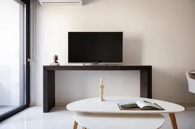 a living room with a tv and a white table at Luxury Apartment, Athens Center, 