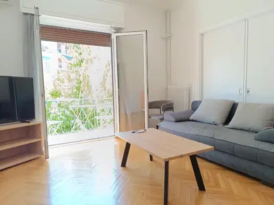 a living room with a couch and a coffee table at Twins apartments - museum in Athens