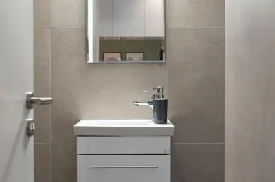 a bathroom with a sink and a mirror at Twins apartments - museum in Athens