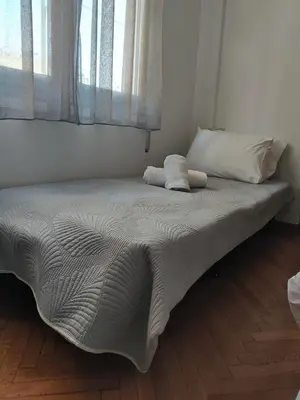 a bed with two pillows on it in a bedroom at Twins apartments - museum in Athens