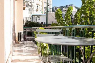 a patio with tables and chairs on a balcony at Twins apartments - museum in Athens