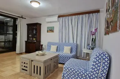 a living room with two chairs and a table at Villa Aura - Thymari in Sounio