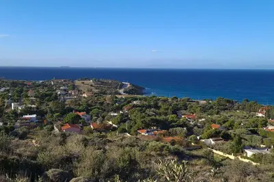 an aerial view of a town and the ocean at Villa Aura - Thymari in Sounio