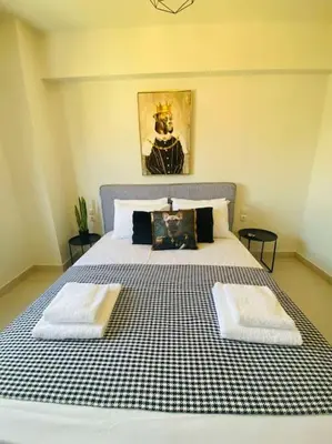 a bedroom with a bed with two towels on it at New 2BD aprt with Shared Rooftop Pool D3 in Athens