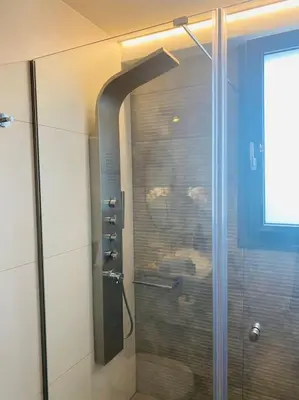 a shower with a glass door in a bathroom at New 2BD aprt with Shared Rooftop Pool D3 in Athens