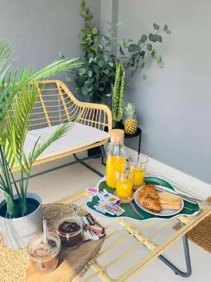 a table with a tray of food and two glasses of orange juice at New 2BD aprt with Shared Rooftop Pool D3 in Athens