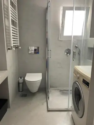 a bathroom with a shower and a toilet and a sink at Acropolis Terrace View Apartment in Athens