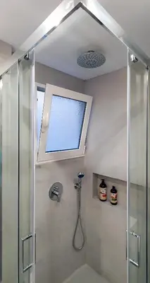 a bathroom with a shower with a window and a sink at Acropolis Terrace View Apartment in Athens