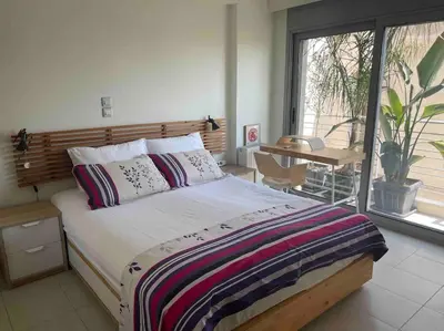 a bedroom with a bed and a balcony with a table at Lovely Maisonette next to Acropolis in Athens