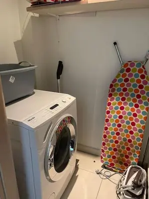 a washer and dryer in a laundry room at Lovely Maisonette next to Acropolis in Athens