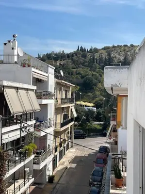 an aerial view of a street with cars parked in front of buildings at Lovely Maisonette next to Acropolis in Athens