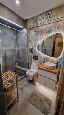 a bathroom with a toilet and a sink and a mirror at Lovely Maisonette next to Acropolis in Athens