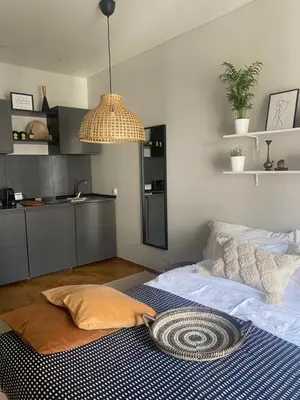 a bedroom with a bed with a blue and white rug at City Boho studio in Athens