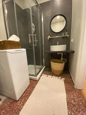 a bathroom with a shower and a sink and a mirror at City Boho studio in Athens