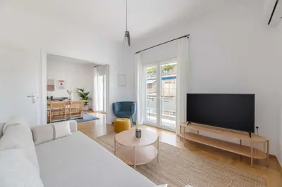a living room with a couch and a flat screen tv at Flawless 1BR Apartment in Athens by UPSTREET in Athens