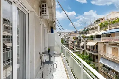 a balcony with a table and chairs on it at Flawless 1BR Apartment in Athens by UPSTREET in Athens
