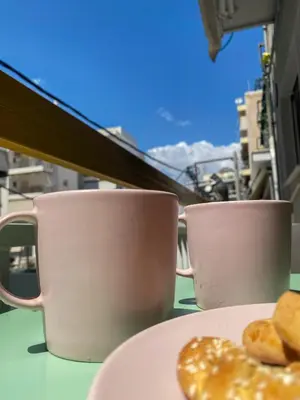 two coffee cups and a plate of donuts on a table at Green ART House Athens in Athens