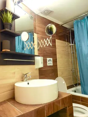 a bathroom with a sink and a toilet and a mirror at Green ART House Athens in Athens