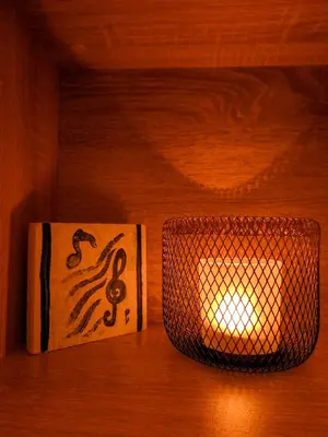 two playing cards and a candle on a wooden floor at Green ART House Athens in Athens