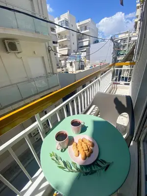 a plate of food on a table on a balcony at Green ART House Athens in Athens