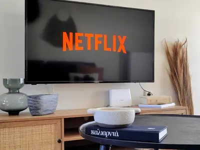 a flat screen tv sitting on top of a table at Funky Boho Kallithea Loft in Athens