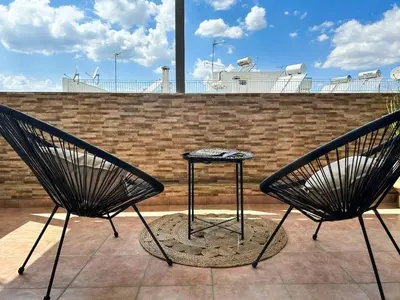 two black chairs and a table on a roof at Funky Boho Kallithea Loft in Athens